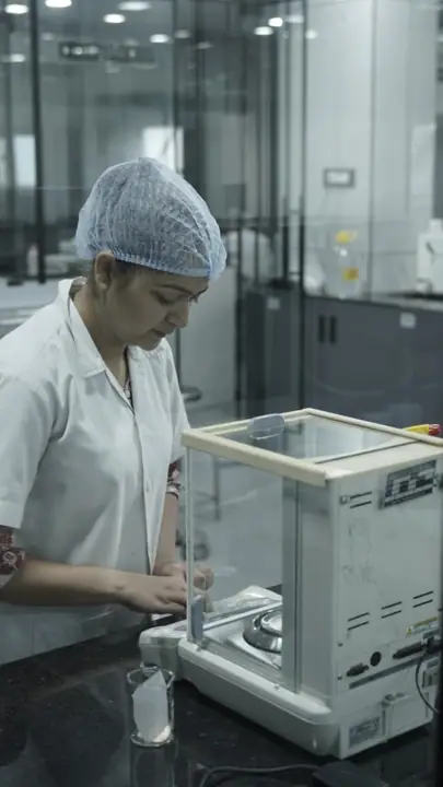 Analyst weighing a sample on an analytical balance