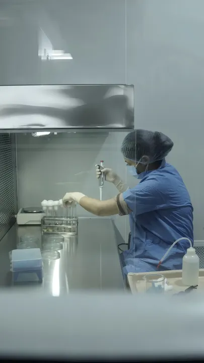 Microbiologist working in a laminar air-flow cabinet